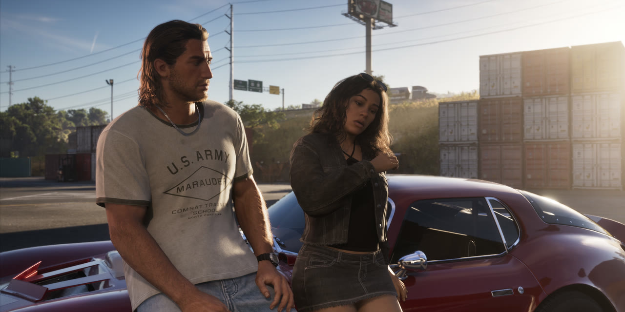 Jason in a U.S. Army T-shirt and Lucia by a red car