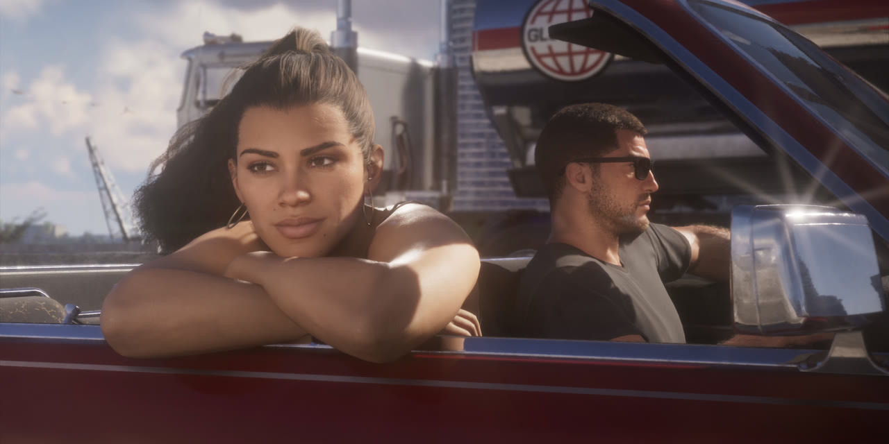 Lucia leaning on the door of a convertible driven by Jason