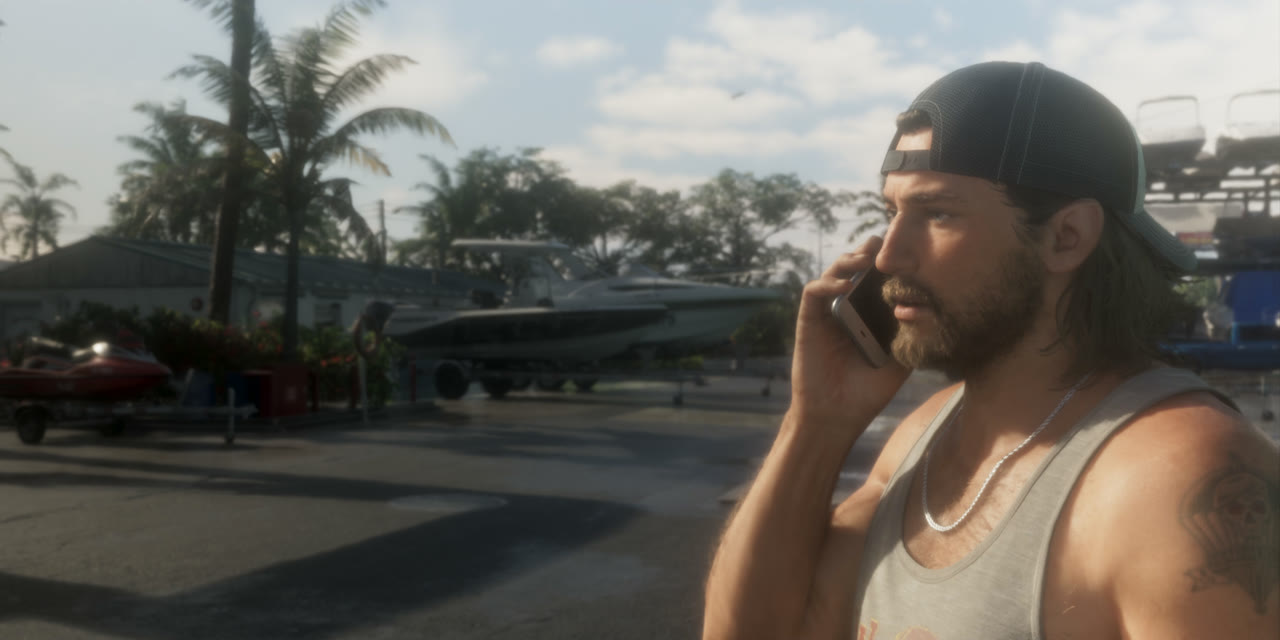 Long-haired Jason on the phone at a marina